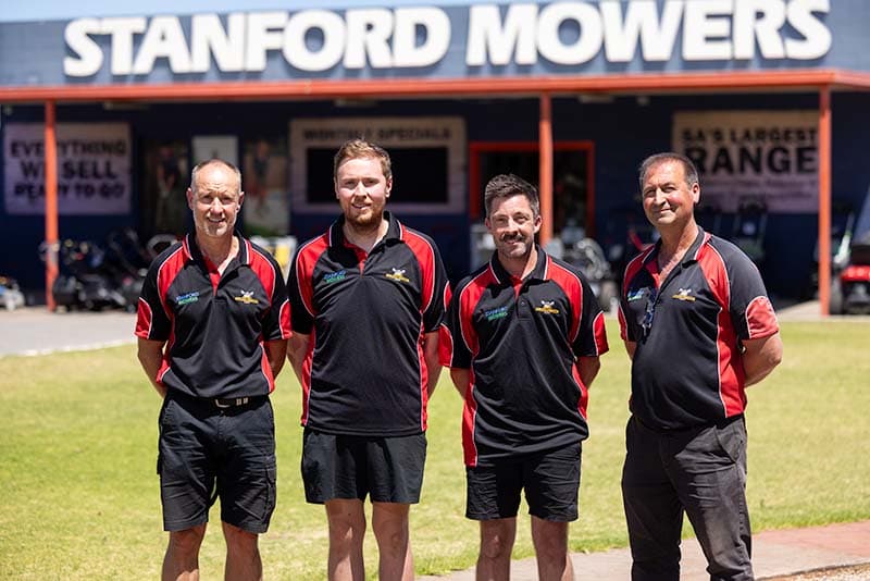 Team in front of Stanford Mowers store