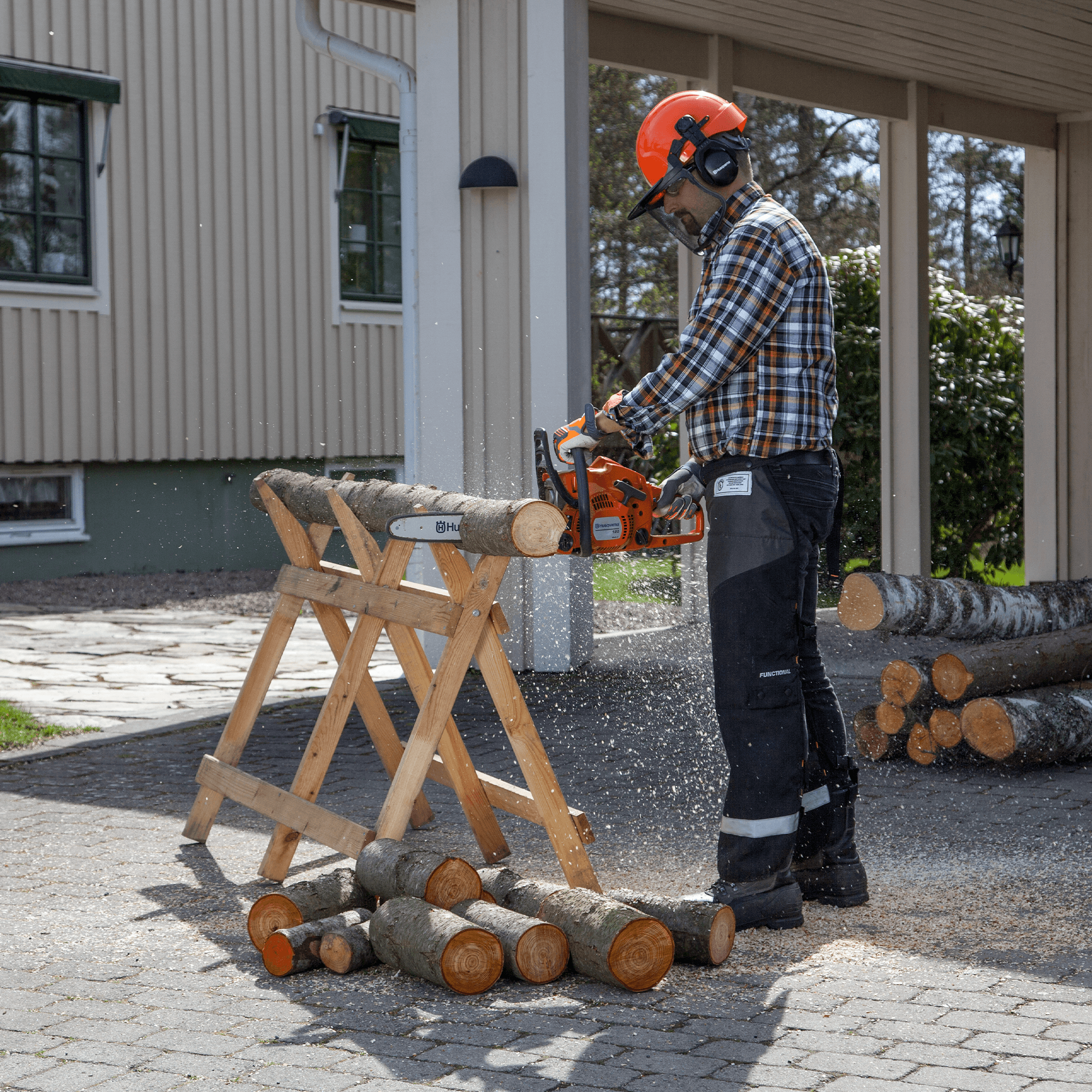 man wearing ppe with chainsaw
